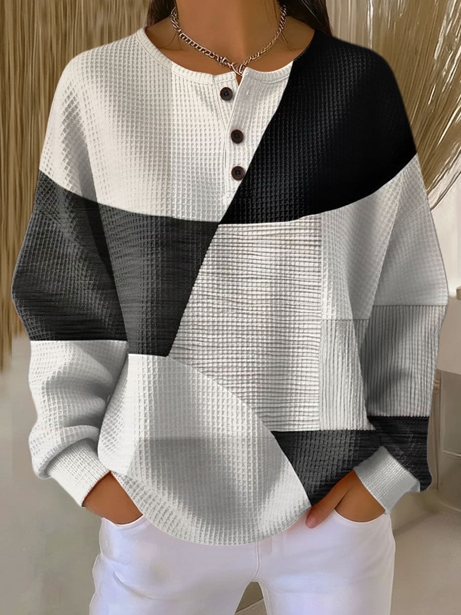 Colorblock long-sleeve henley sweater with black and white panels