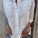 White embroidered long-sleeve cardigan with lace panel and button front, collared