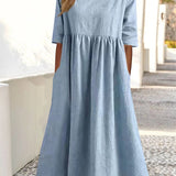 Light blue midi dress with crew neck, 3/4 sleeves, and gathered waist