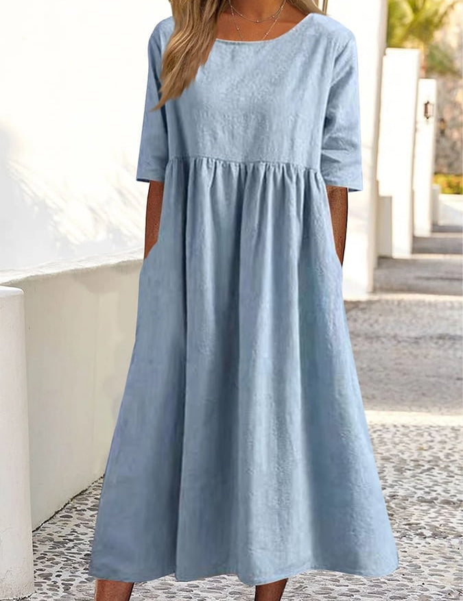 Light blue midi dress with crew neck, 3/4 sleeves, and gathered waist