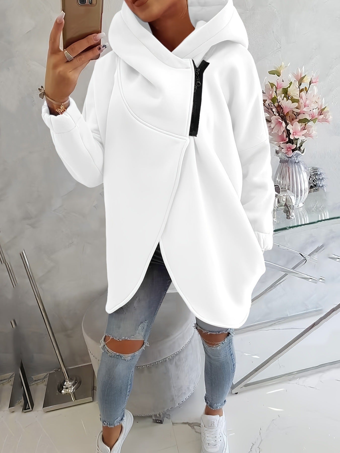 White zip-up hoodie with hood, front pocket, and black zipper detail