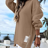 Tan cropped pullover with long sleeves and front zip detail, ribbed hem