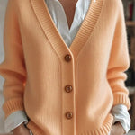 Light orange knit V-neck cardigan with button front and ribbed cuffs, long sleeves