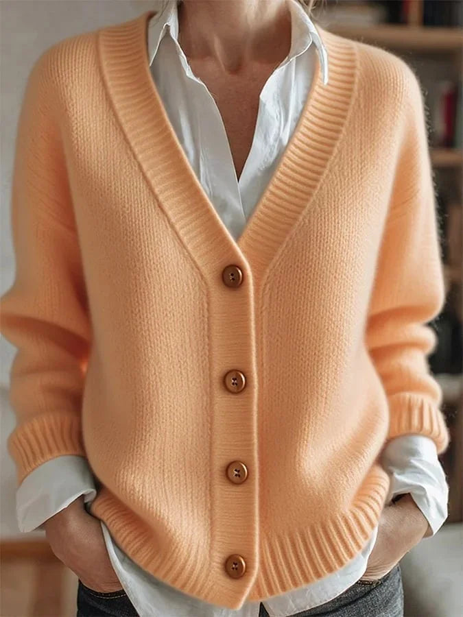 Light orange knit V-neck cardigan with button front and ribbed cuffs, long sleeves