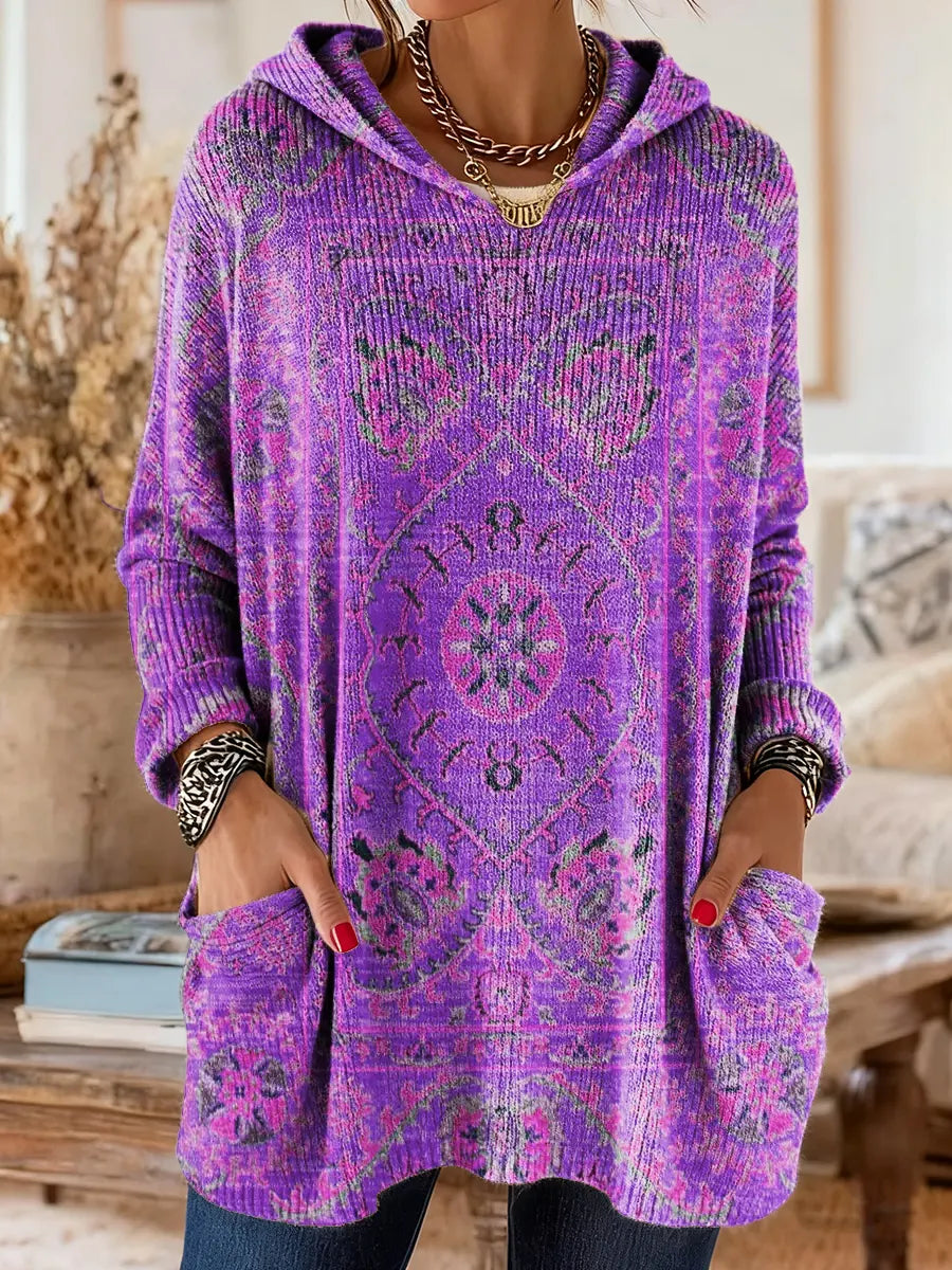 Purple hooded knit tunic with long sleeves, front pockets, and ornate ethnic print