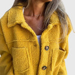 Yellow sherpa jacket close-up with button front and chest flap pocket