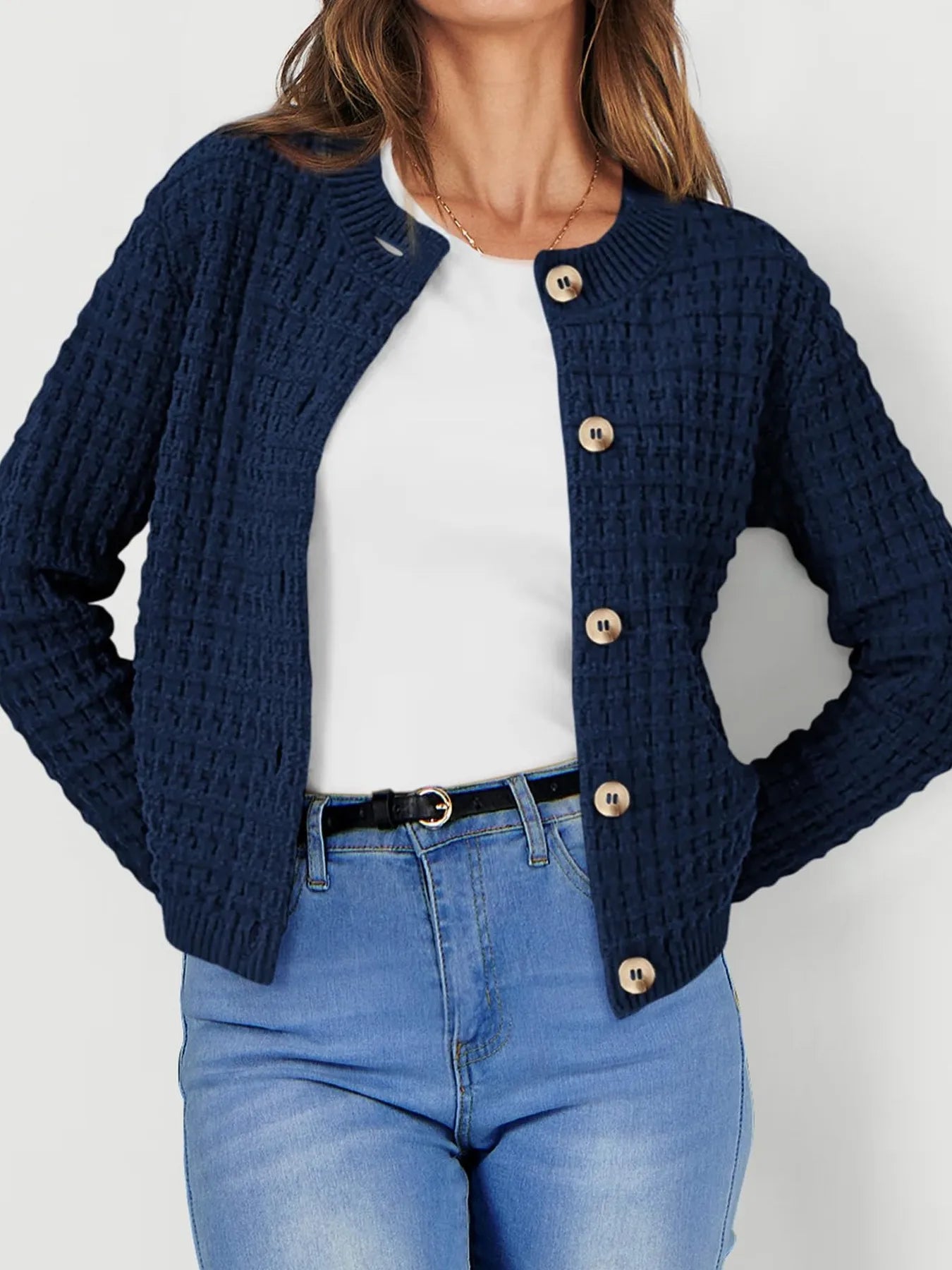 Navy knit cardigan with button front and long sleeves, textured waffle pattern