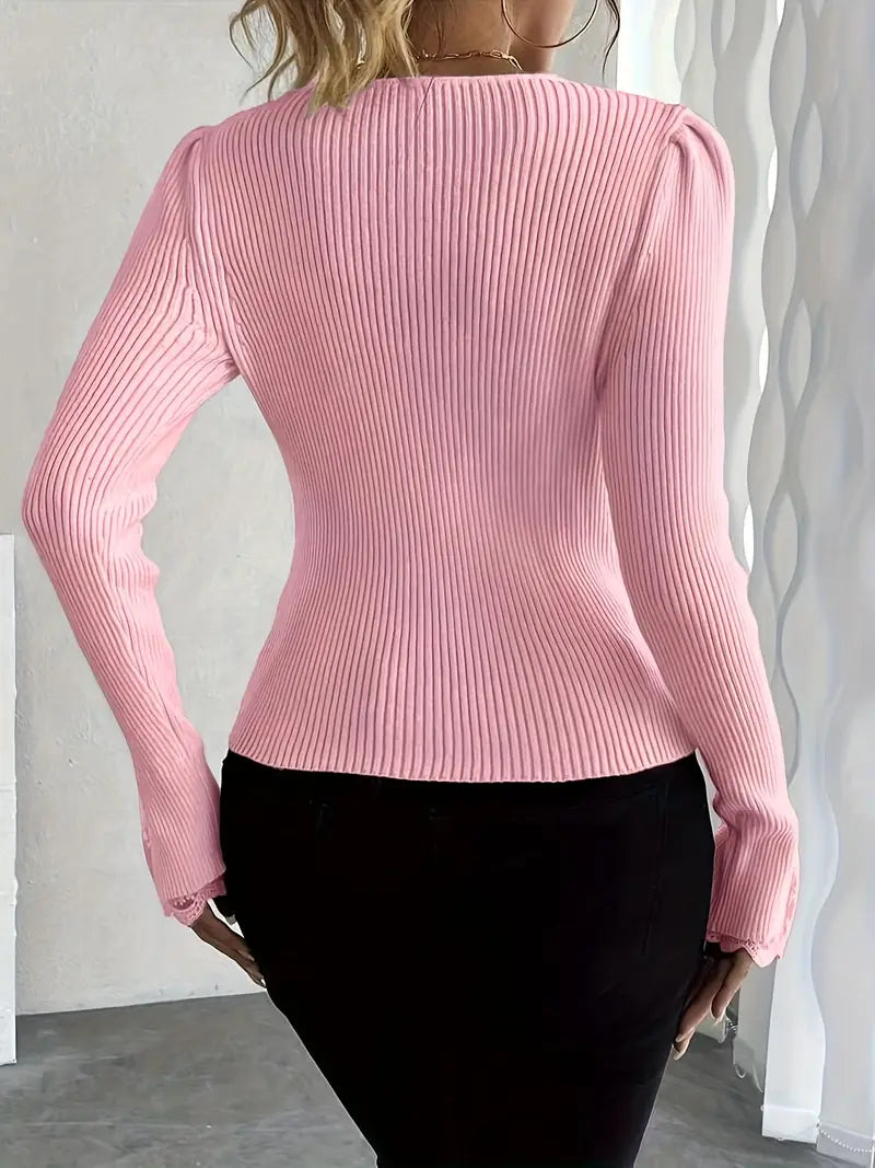 Pink ribbed knit long-sleeve top with rounded back and fitted waist