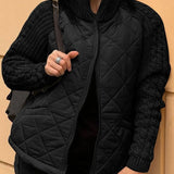 Black quilted cardigan vest with long knit sleeves and front zipper