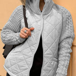 Light gray quilted cardigan vest with front zipper and textured gray knit sleeves