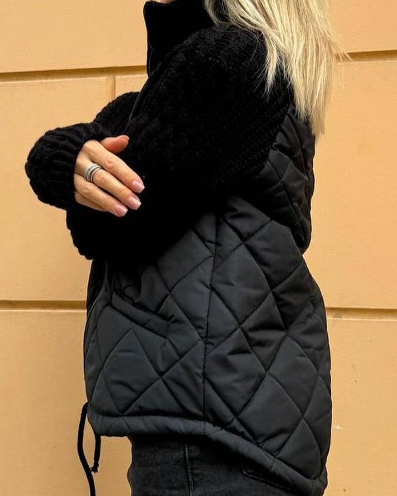 Black quilted cardigan vest with long knit sleeves and front zipper