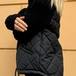Black quilted cardigan vest with long knit sleeves and front zipper