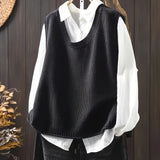 Black sleeveless knit Grace cardigan with ribbed cowl neck and button placket