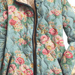 Quilted floral women’s jacket close-up, teal-blue with roses, button placket and trim