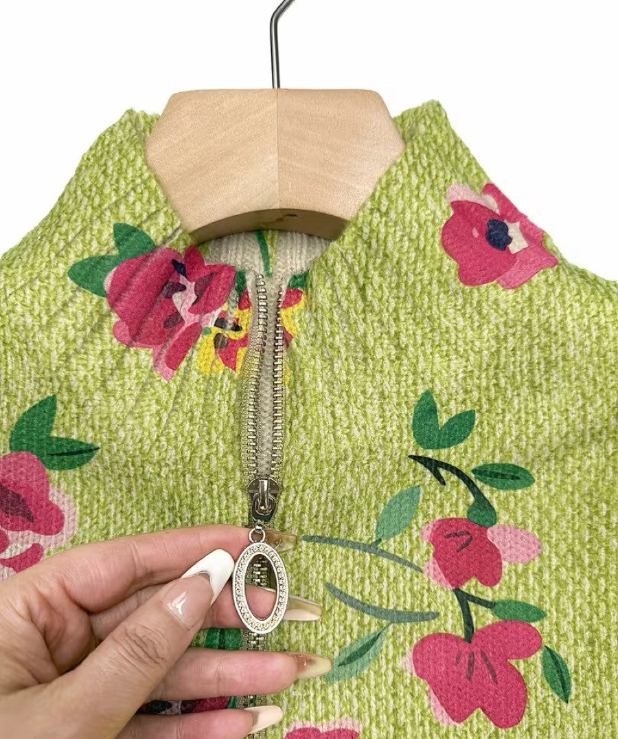 Close-up of floral knit cardigan zipper and lime green fabric texture