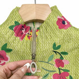 Close-up of floral knit cardigan zipper and lime green fabric texture