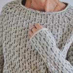 Womens speckled knit pullover with crew neckline and long sleeves, ribbed collar