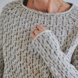Womens speckled knit pullover with crew neckline and long sleeves, ribbed collar
