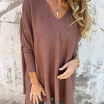 Brown V-neck pullover sweater, three-quarter sleeves and loose drape.