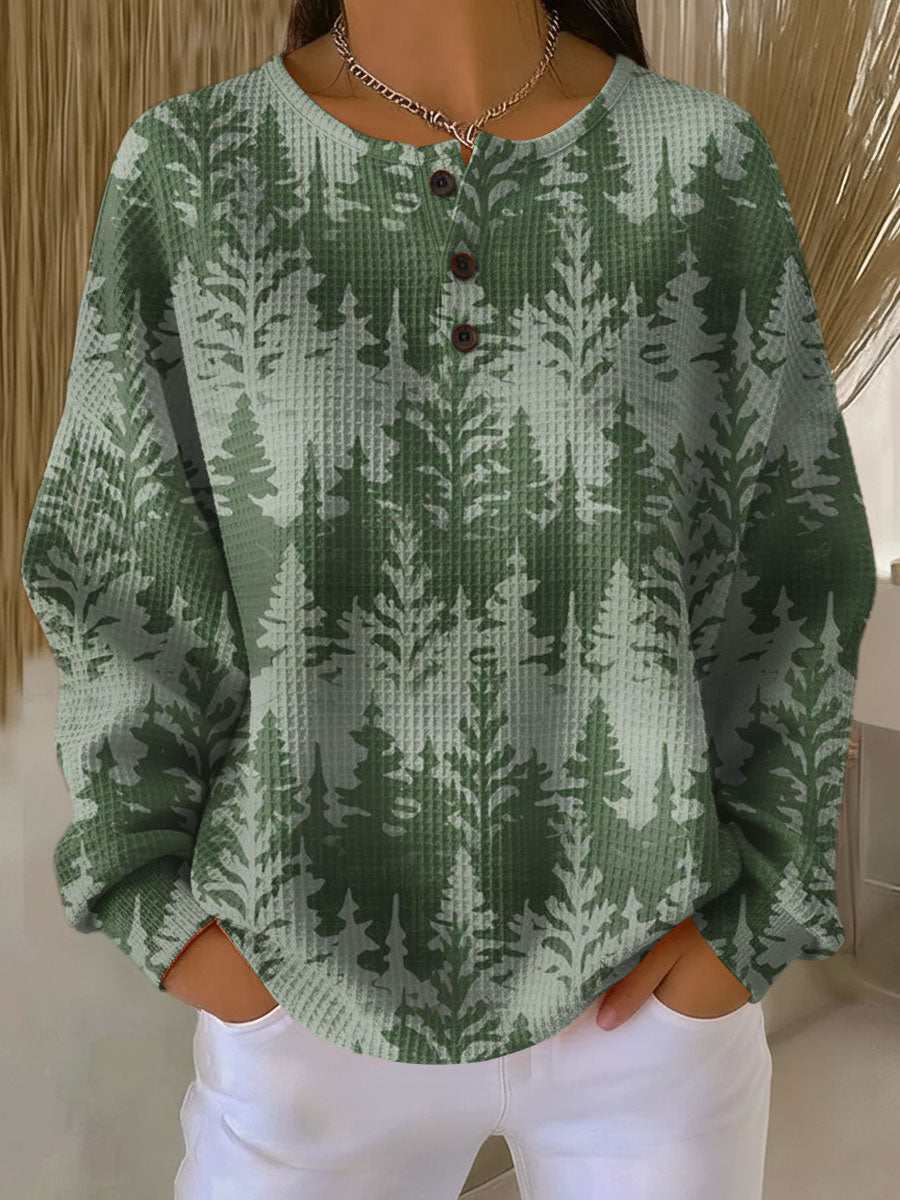 Green knit sweater with classic tree pattern and button-front henley neckline
