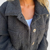 Dark gray sherpa jacket close-up with button front and chest flap pocket
