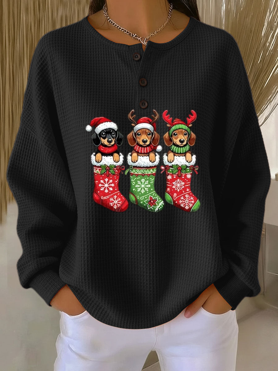 Black vintage Christmas henley sweater with dog motif and festive stockings graphic