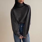Dark gray ribbed knit pullover with high neck and long sleeves, side view