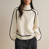 White knit pullover with high ribbed turtleneck and black contrast trim