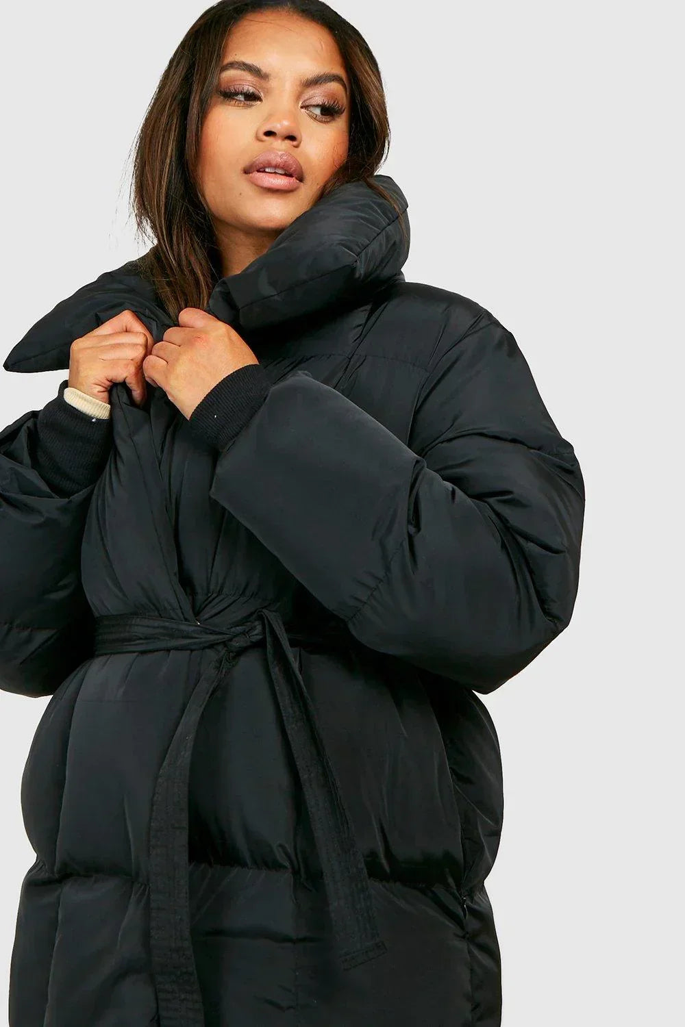 Black padded hooded jacket with wide cuffs, tie belt, snap button front.