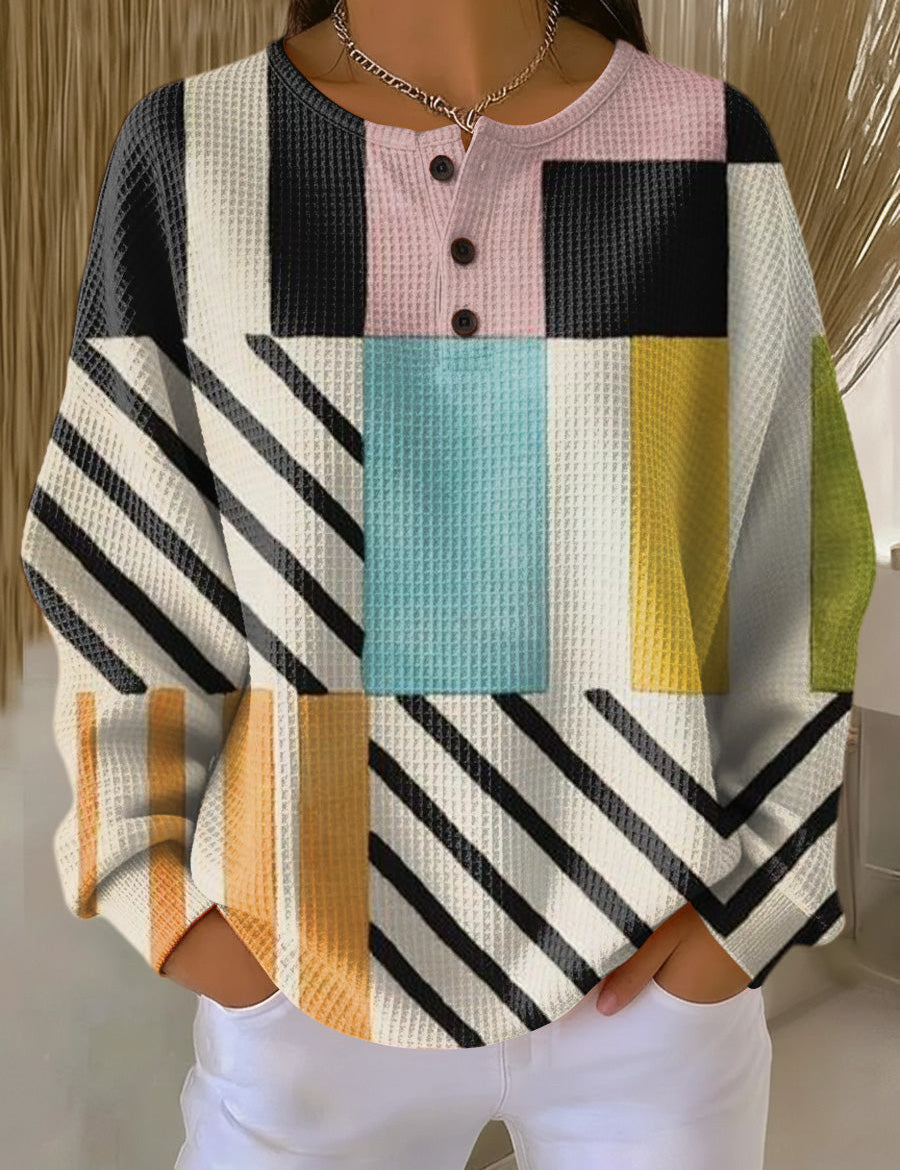 Colorblock pullover sweater with plaid and stripe panels, long sleeves, button placket