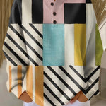 Colorblock pullover sweater with plaid and stripe panels, long sleeves, button placket