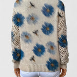 Back view of relaxed floral pullover, cream knit with blue flower pattern, long sleeves