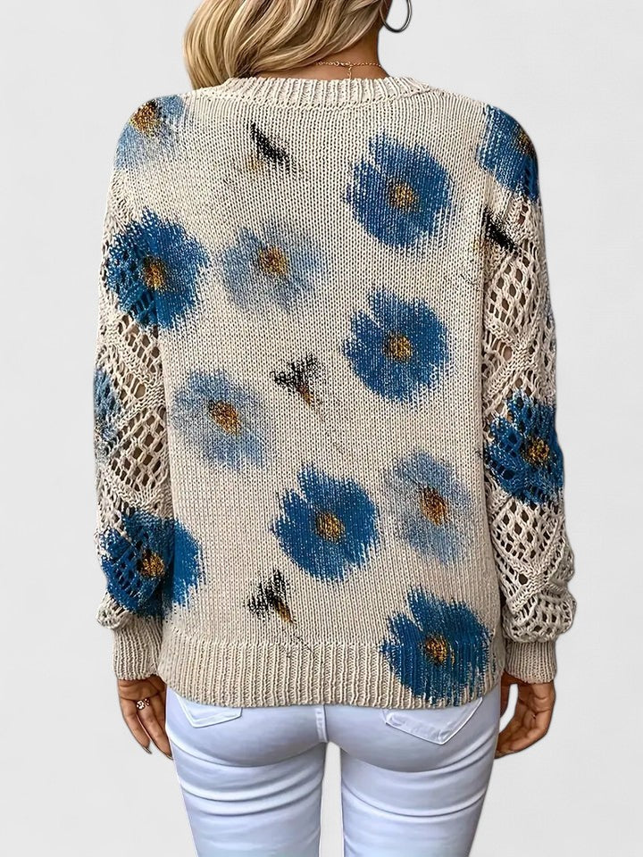 Back view of relaxed floral pullover, cream knit with blue flower pattern, long sleeves