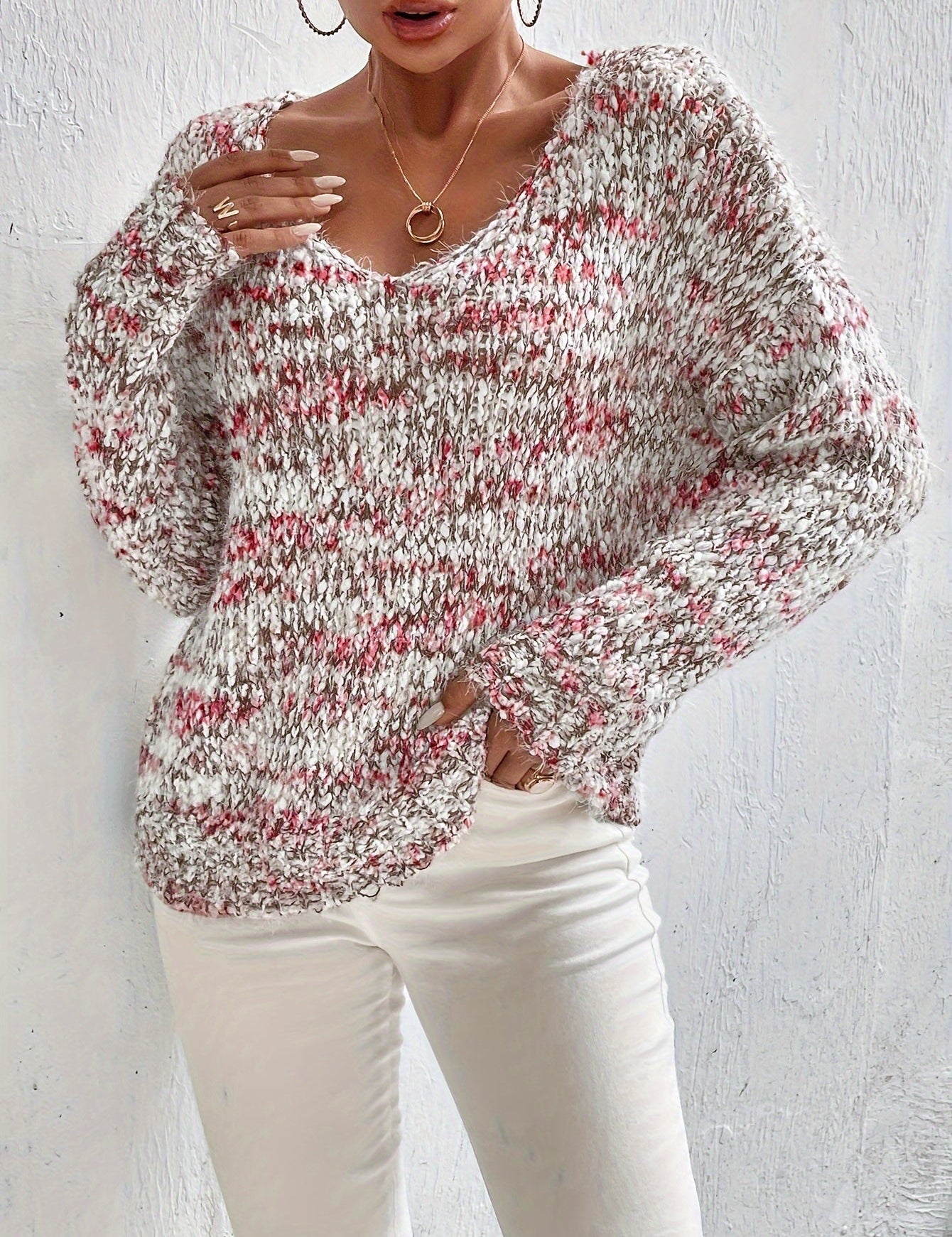 Loose knit pullover sweater with long sleeves, red-and-white speckled texture