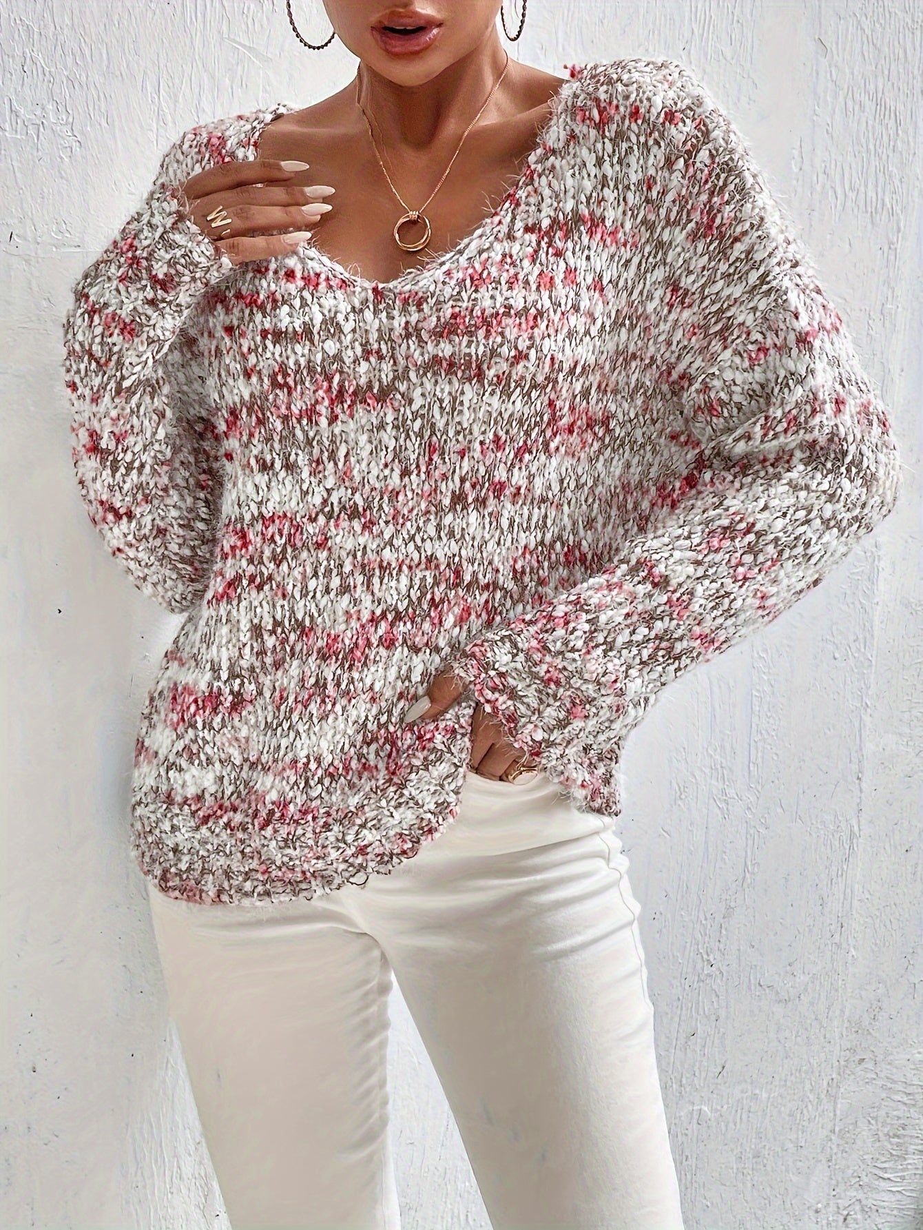 Loose knit pullover sweater with long sleeves, red-and-white speckled texture