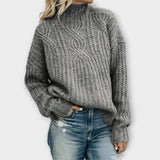 Gray cable-knit cozy sweater with mock neck and long sleeves