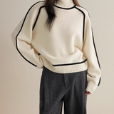 Off-white turtleneck sweater with black trim, ribbed hem and cuffs