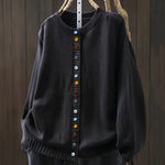 Black cardigan sweater with multicolor button front and ribbed crew neckline