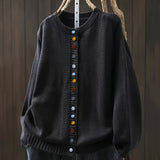 Black cardigan sweater with multicolor button front and ribbed crew neckline