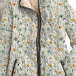 Women's quilted floral jacket, close view of zip front, floral buttons and collar