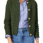Dark green knit cardigan with button front and ribbed cuffs, worn over striped shirt