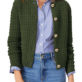 Dark green knit cardigan with button front and ribbed cuffs, worn over striped shirt