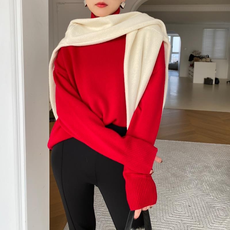 Red long-sleeve turtleneck sweater with cream draped wrap at neck