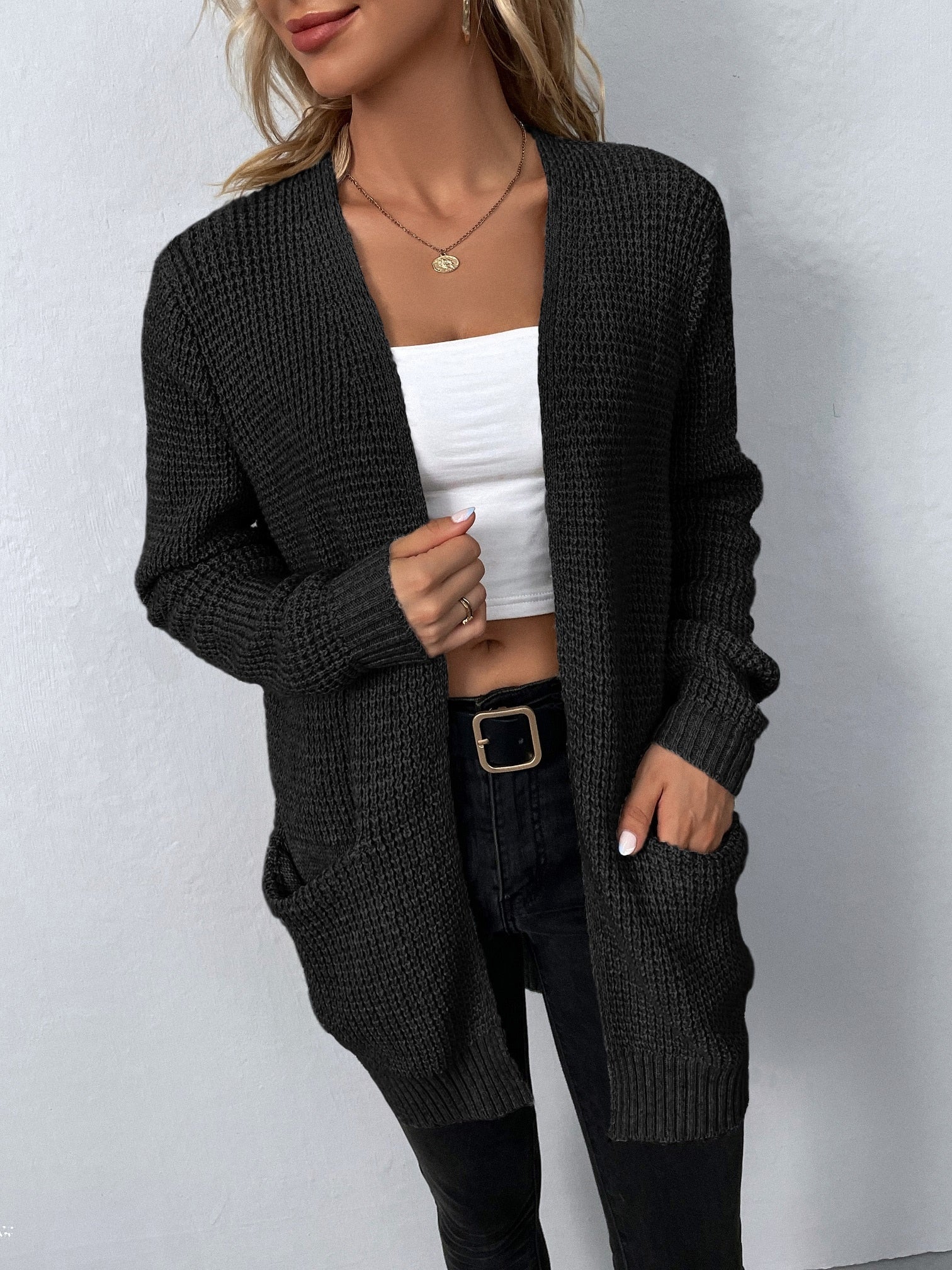 Black knit cardigan with open front and two patch pockets, long sleeves