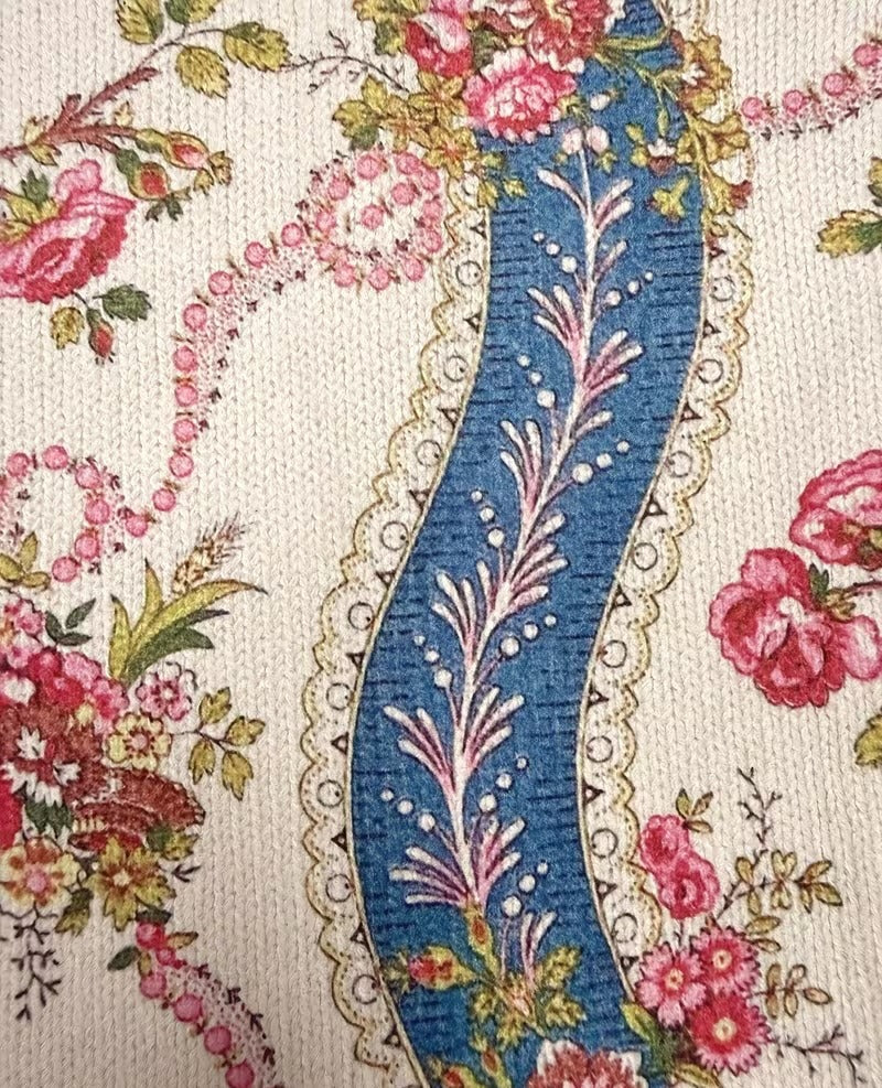 Rib-knit jacket fabric close-up with climbing rose floral and blue stripe panel