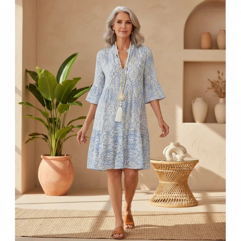 Boho-style mini dress in light blue and white print, V-neck, flared sleeves, tiered hem