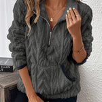 Dark gray fuzzy quarter-zip pullover with short sleeves and navy-trim accents