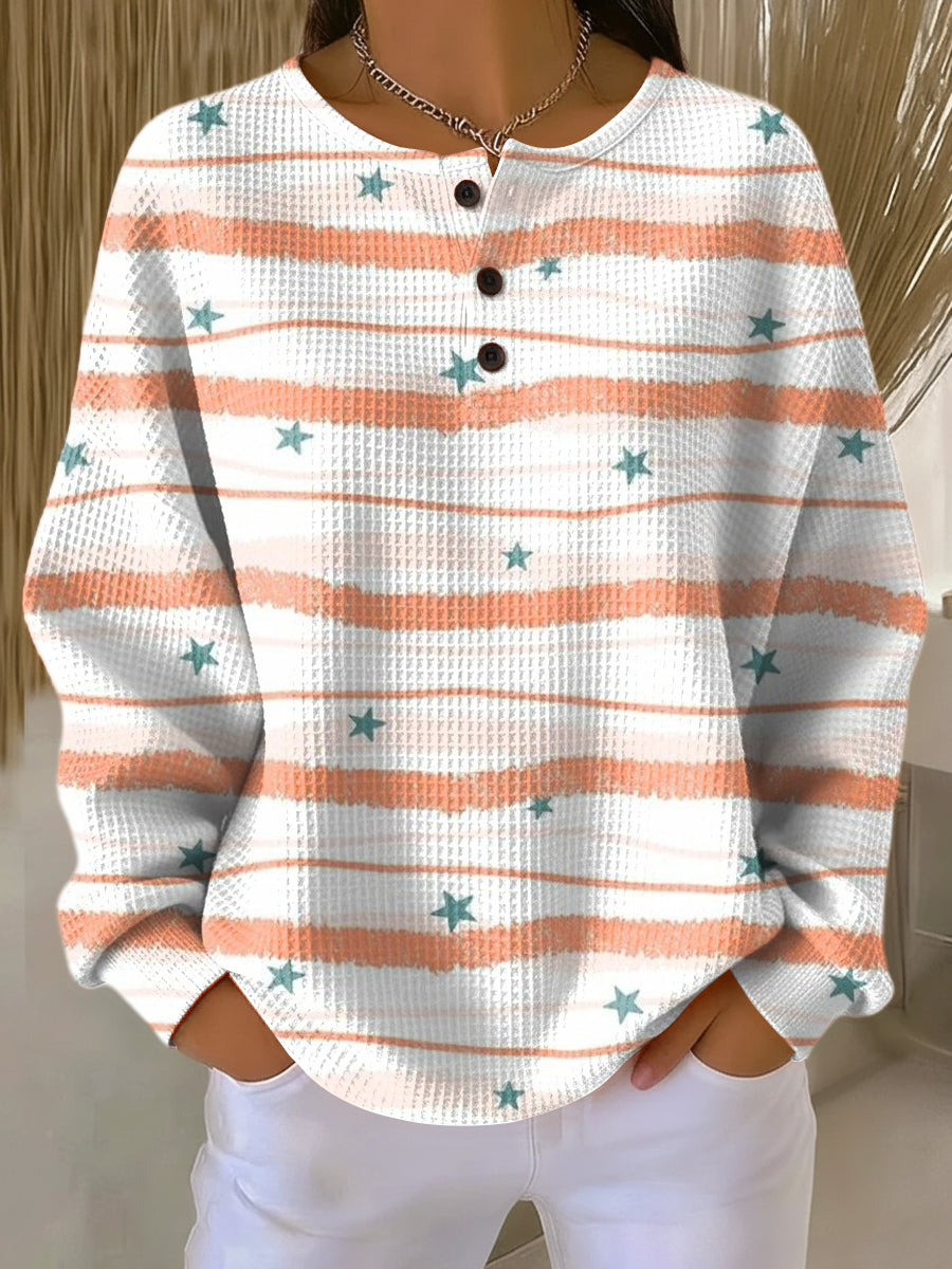 Women’s white and orange striped star pullover sweater with henley button placket