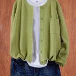 Light green round-neck cardigan with button front and side pocket
