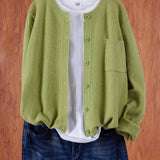 Light green round-neck cardigan with button front and side pocket